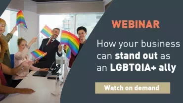 Group holding pride flags in office promoting LGBTQIA+ ally webinar.