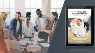 Group working on a project around a table, next to an image of an eBook on hiring strategies.